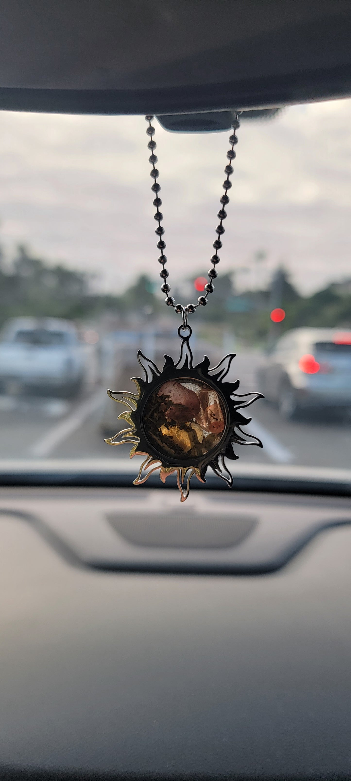Drive toward success with this Sun Rearview Mirror Charm. A spelled car amulet for success, confidence, clarity, and abundance—perfect for spiritual travelers.