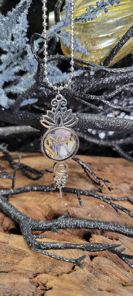 Bring peace and protection on the road with this Lotus Rear View Mirror Charm. A spelled car amulet crafted with calming energy, herbs, and crystals.