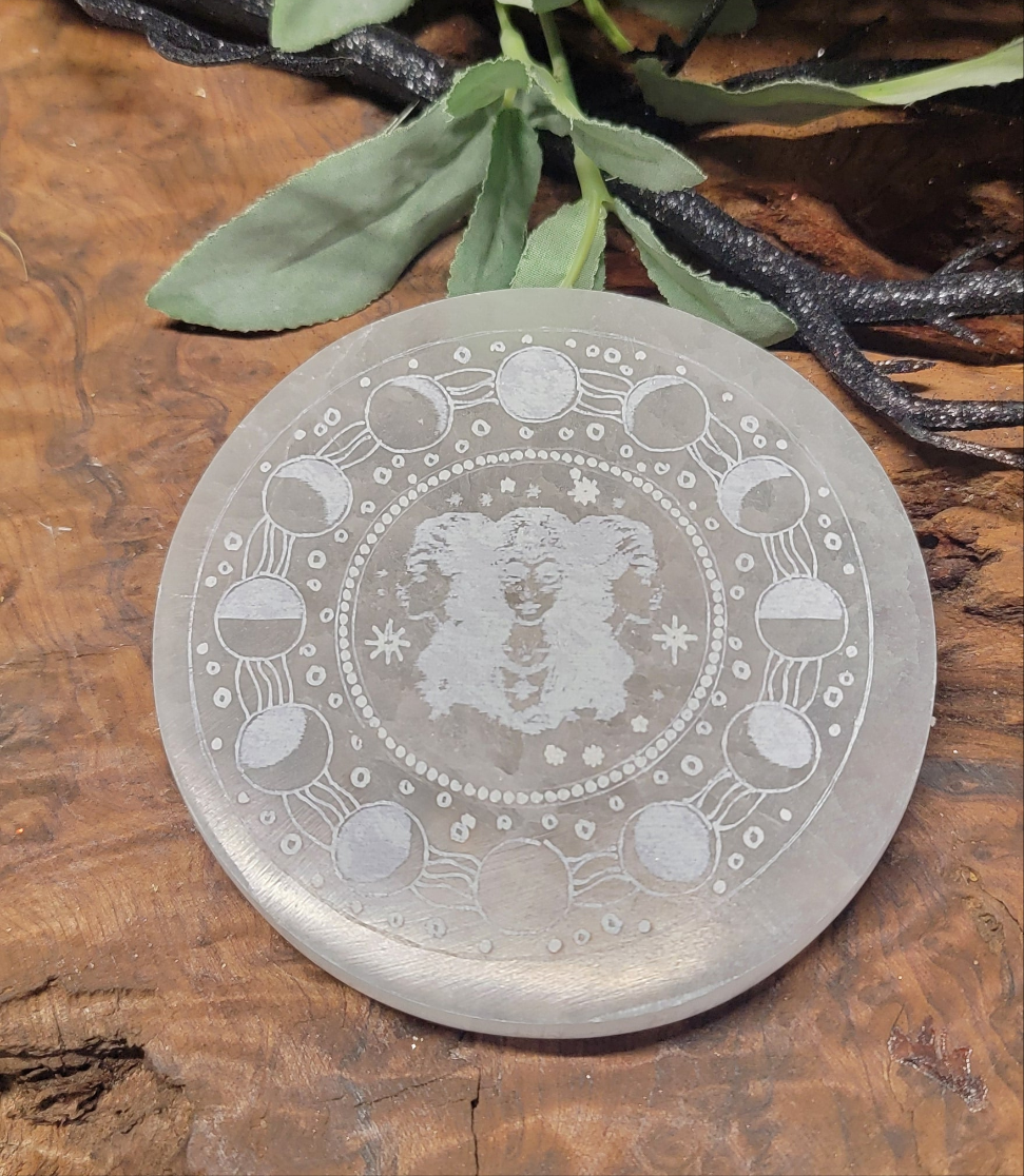 Round Selenite plate with the triple moon goddess, surrounded by the lunar moonface