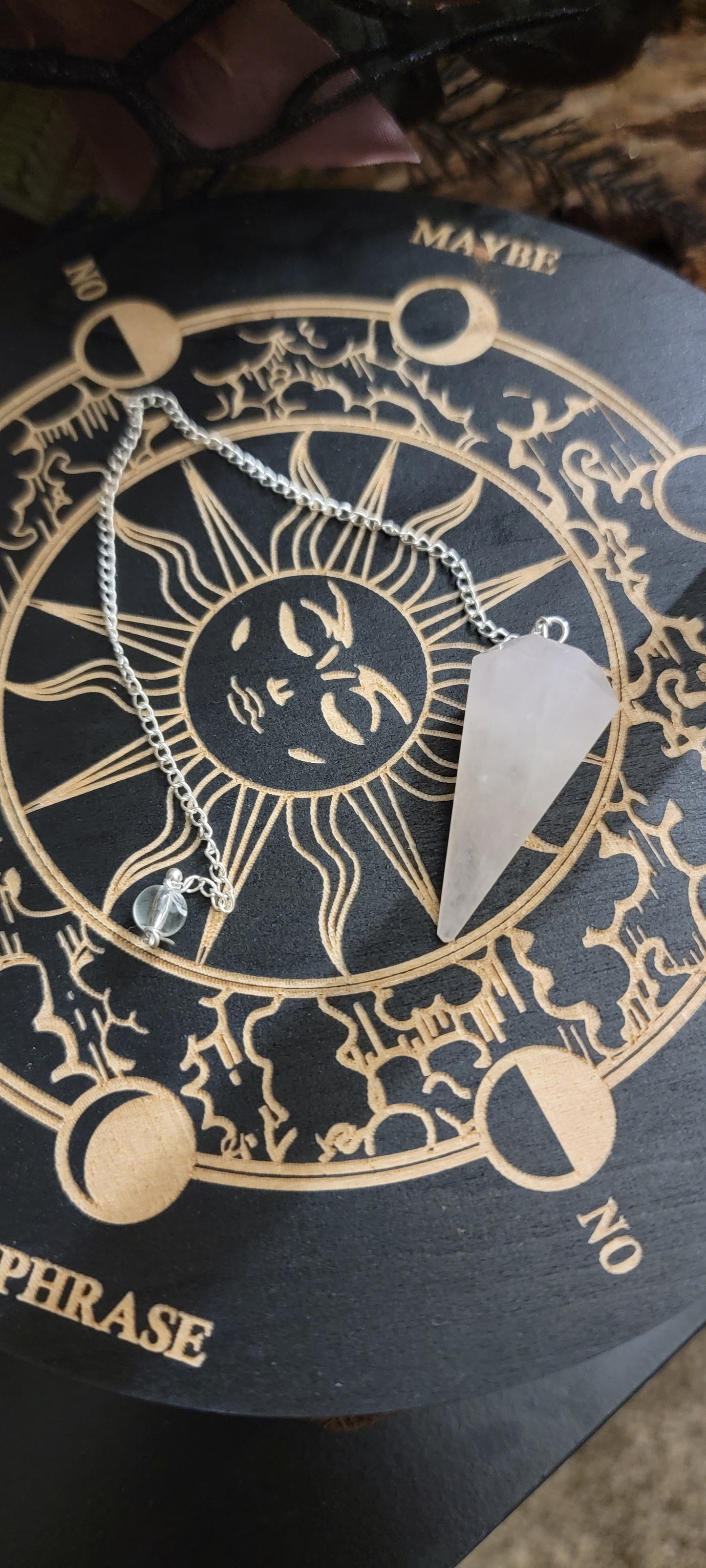 Smooth pointed rose quartz, pendulum hanging on a chrome chain