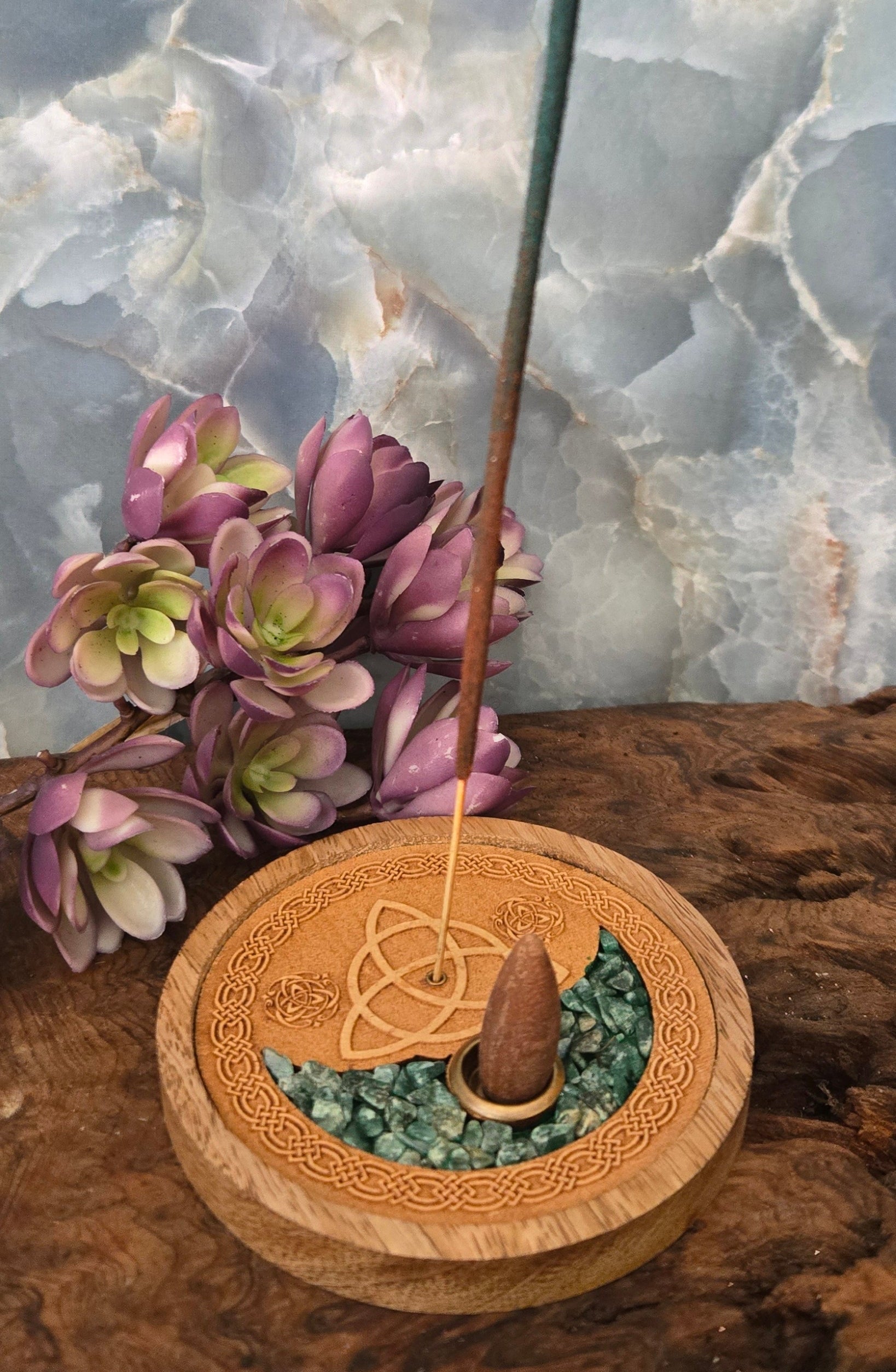 Decorative object with a Celtic knot design on a stone surface