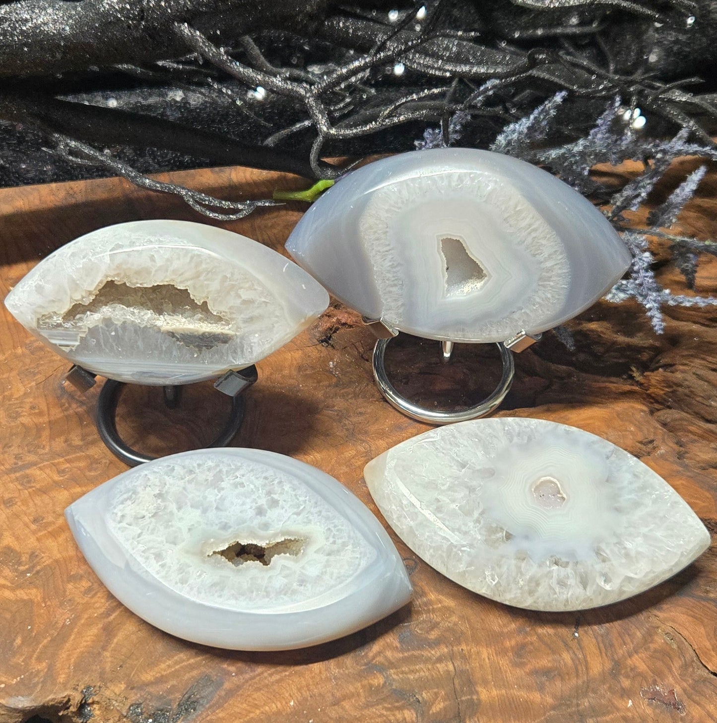 Four agate Evil Eye on stands with a decorative background