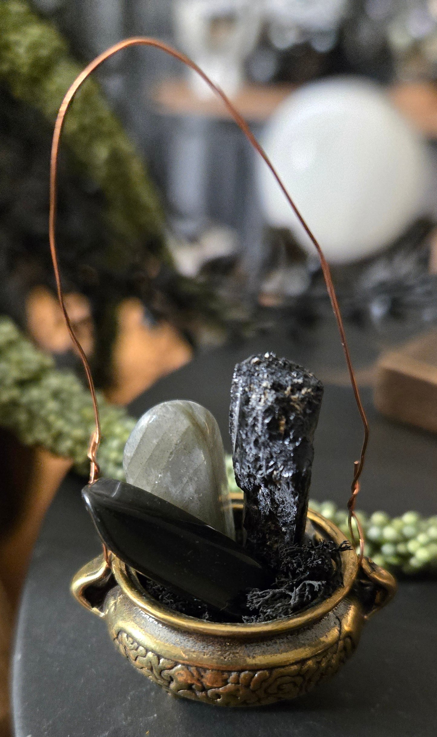 Close-up of a decorative item with a metallic finish on a dark surface