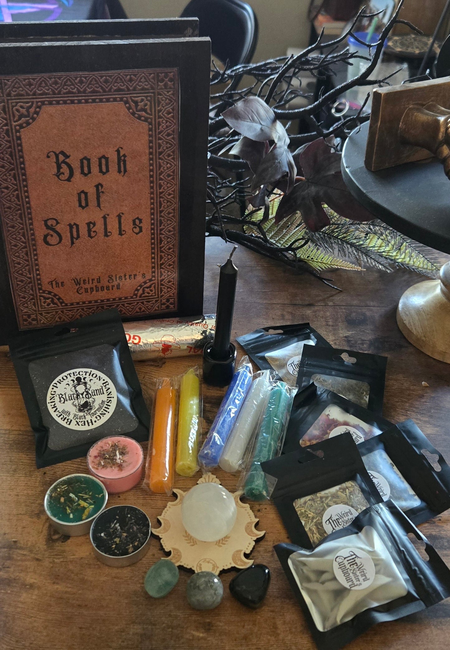 Individually package herbs, chime candles, spelled tea lights.
Crystals black sand with a book of spells wooden storage box