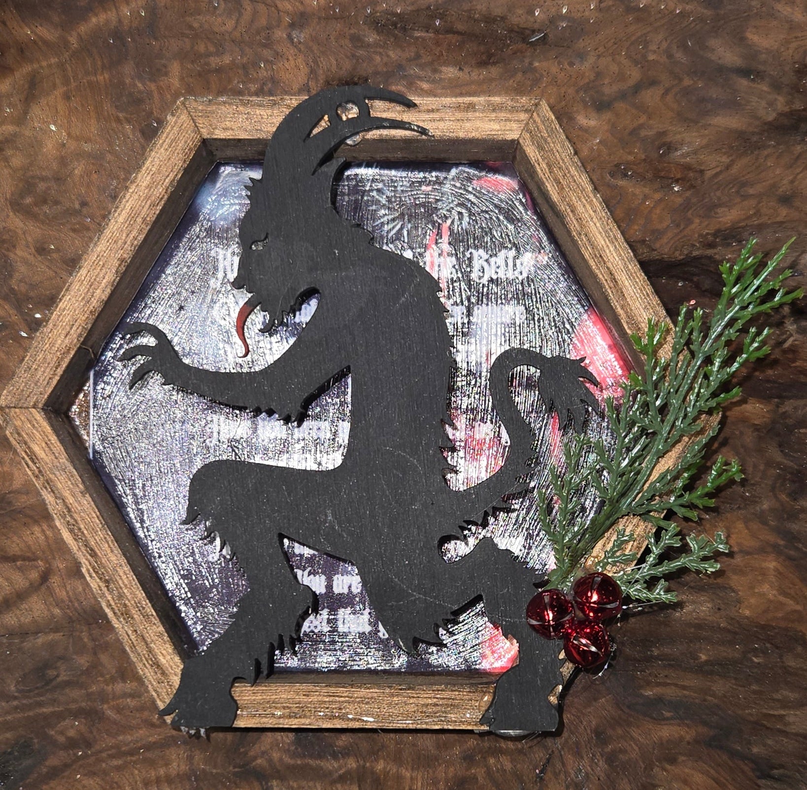 Decorative wooden box with a black silhouette of krampus on a textured carol of the bells lyrics