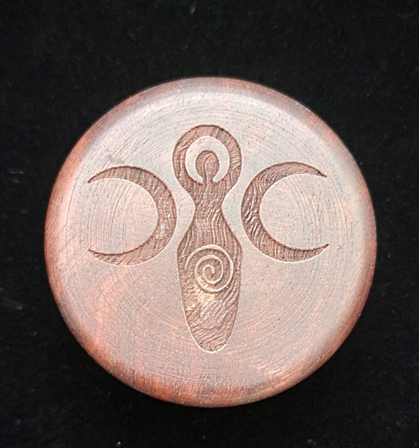 Small wooden herb grinder with triple moon goddess etched onto the face